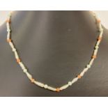 A baroque pearl, turquoise and coral bead necklace with 9ct gold clasp.