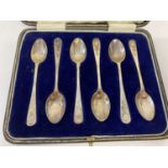 A cased set of silver coffee spoons with floral decoration to handles.