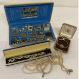 A small vintage jewellery box with interior compartments containing a collection of vintage costume
