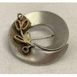 A Scandinavian style silver and 9ct gold brooch.