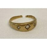 A vintage gypsy style ring set with 3 diamonds. Cut through so suitable for scrap or repair.