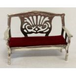 A 925 silver pin cushion in the shape of a bench seat with red velvet cushion.