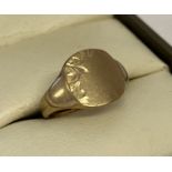 A vintage 9ct gold child's signet ring with engraved decoration to one side and corner.