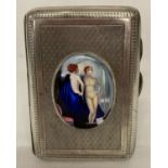 A hallmarked silver cigarette case with engine turned detail & ceramic oval plaque depicting a nude.