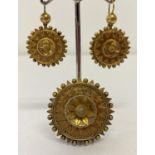 A Victorian highly decorative gold mourning brooch and matching drop earrings.