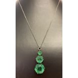 A vintage silver necklace with graduating round cut green fluorite drop pendant.