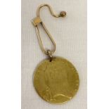 A 22ct gold 1793 George III half guinea coin with 14ct gold bale on a 14ct gold button hook brooch.
