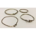 4 vintage and modern silver and white metal bracelets.
