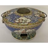 An antique hand painted ceramic wine warmer.