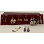 8 pairs of silver and white metal drop style earrings.