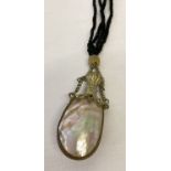 A vintage abalone shell hanging perfume bottle.
