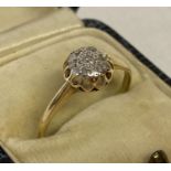 An vintage 18ct gold ladies diamond dress ring. Illusion mount set with 7 small round cut diamonds.
