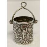 An antique silver thimble bucket with floral decoration and carry handle.