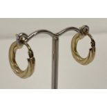 A pair of 9ct gold twist style small hoop earrings.