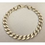 A silver curb chain bracelet with lobster style clasp.