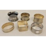 5 silver and 1 white metal vintage serviette rings.