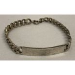 A silver curb chain identity bracelet with empty cartouche and spring clasp.