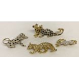 4 gold tone stone set wild cat brooches.