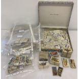 A box of assorted vintage cigarette and tea cards.