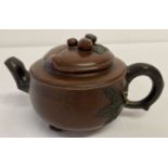 A Chinese Yi-Hsing pottery teapot with fruit and leaf detail.