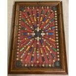 A framed and glazed 3D bespoke display of 12 bore shot gun cartridge cases and mini clay pigeons.