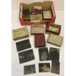 A collection of vintage boxed glass negative plates to include family portraits, boating & railway.