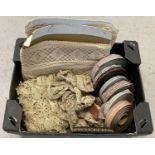 A box of vintage lace edging together with 8 reels of floral ribbon.