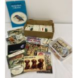 A quantity of assorted cigarette and tea cards, albums and vintage cigarette boxes.