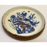 A large hand painted Chinese porcelain stand in blue and brown tones.