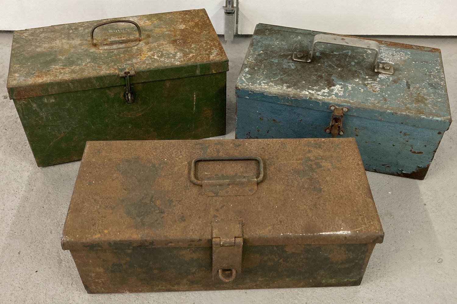 3 vintage tractor style metal tool boxes. One painted blue and one painted green.