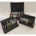 A collection of 62 music cassette tapes in 3 vintage vinyl cases.