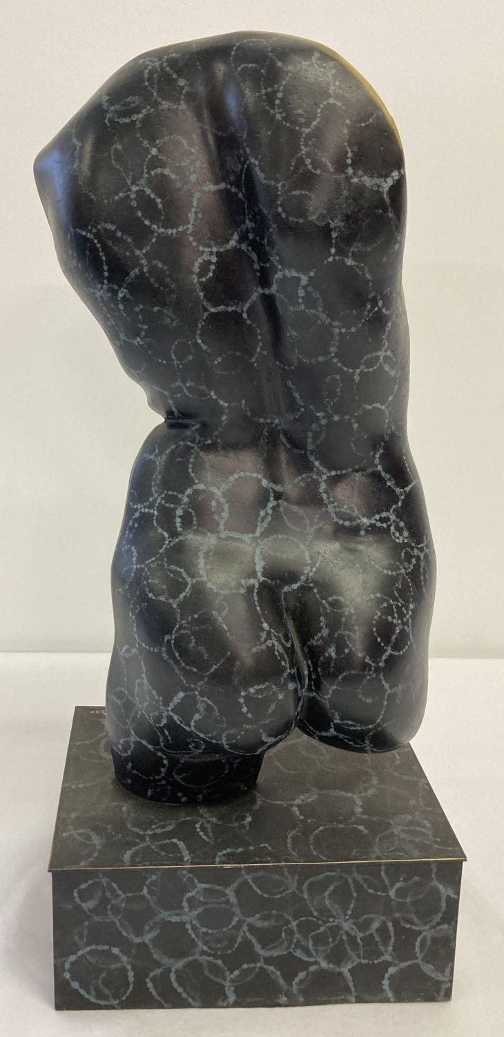 A contemporary bronze nude sculpture with painted detail.