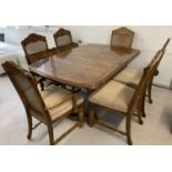 A solid wood dining room table with 4 matching dining chairs and 2 carvers.