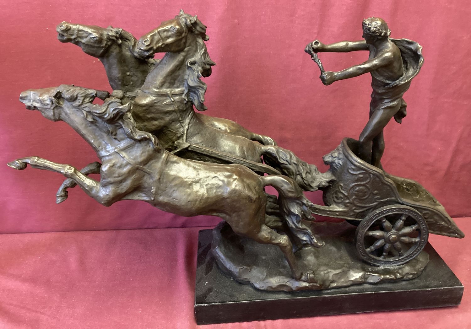 A large marble based bronze figurine of a Chariot racer and 3 rearing horses.