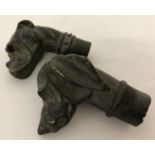 2 bronze walking cane handles in the shape of dogs heads.