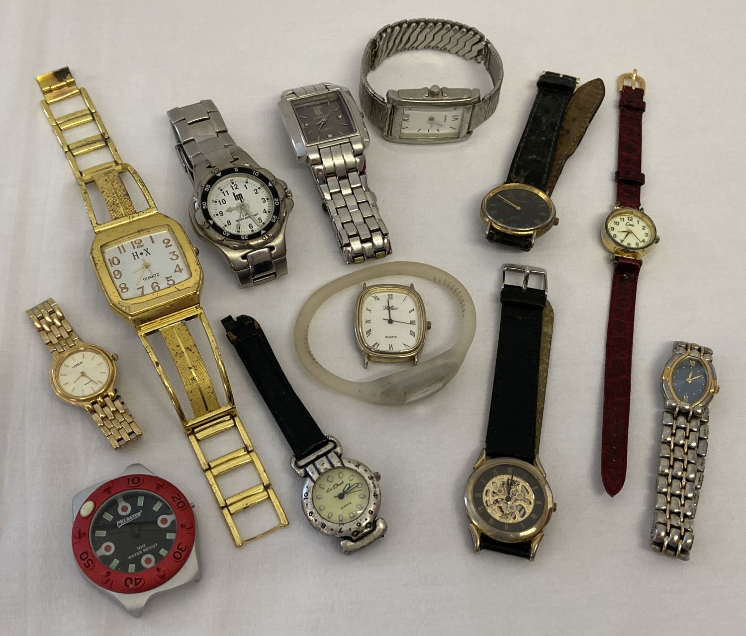 A box of ladies and men's wristwatches in varying styles and conditions.