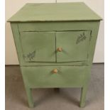 A vintage wooden pot cupboard, painted green in shabby chic style.