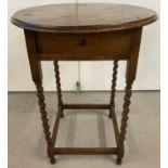 A vintage oak barley twist side table with circular top and drawer.
