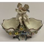 A German porcelain KPM basket with cherubs and floral detail.