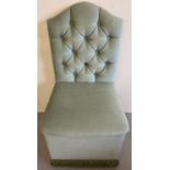 A green velour button backed square bedroom chair with shaped back.