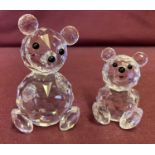 2 Swarovski Crystal teddy bear figurines with black glass eyes and nose detail.