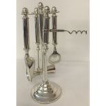 A modern silver plated bar/cocktail tools set with display stand.