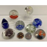 A collection of glass paperweights to include Langham and Maltese glass.