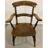 A vintage elm wood bar back arm chair with turned legs and arm supports.