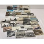 A collection of 50 vintage black & white and colour postcards of ships to include military.