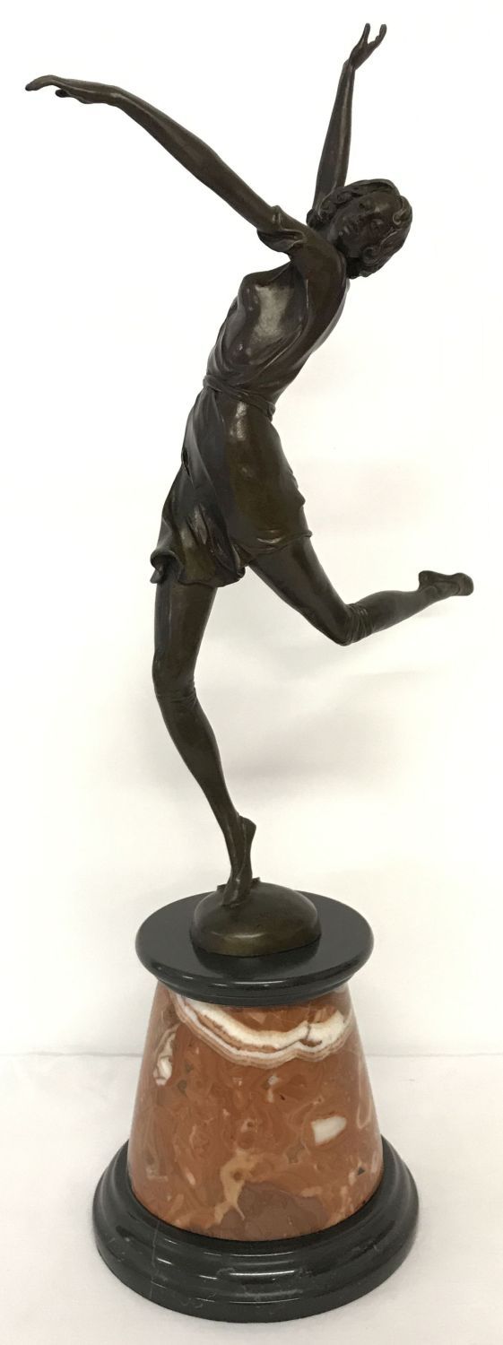 A large Art Deco style bronze figurine of a dancing girl mounted on circular marble plinth.