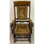 An antique wooden Eastlake platform rocking chair with turned spindle detail to back and arms.