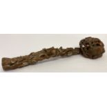 A highly carved wooden Chinese Ruyi sceptre with peach tree design.