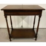 A vintage oak side table with lower shelf, turned legs and beaded detail to top.