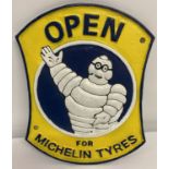 A painted cast iron wall hanging "Open for Michelin Tyres" sign.